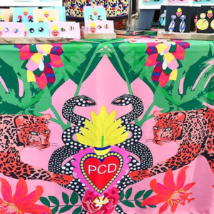 An image of a market stall with a bold printed tablecloth