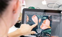 Image of someone creating a design file for a custom printed tablecloth on a laptop